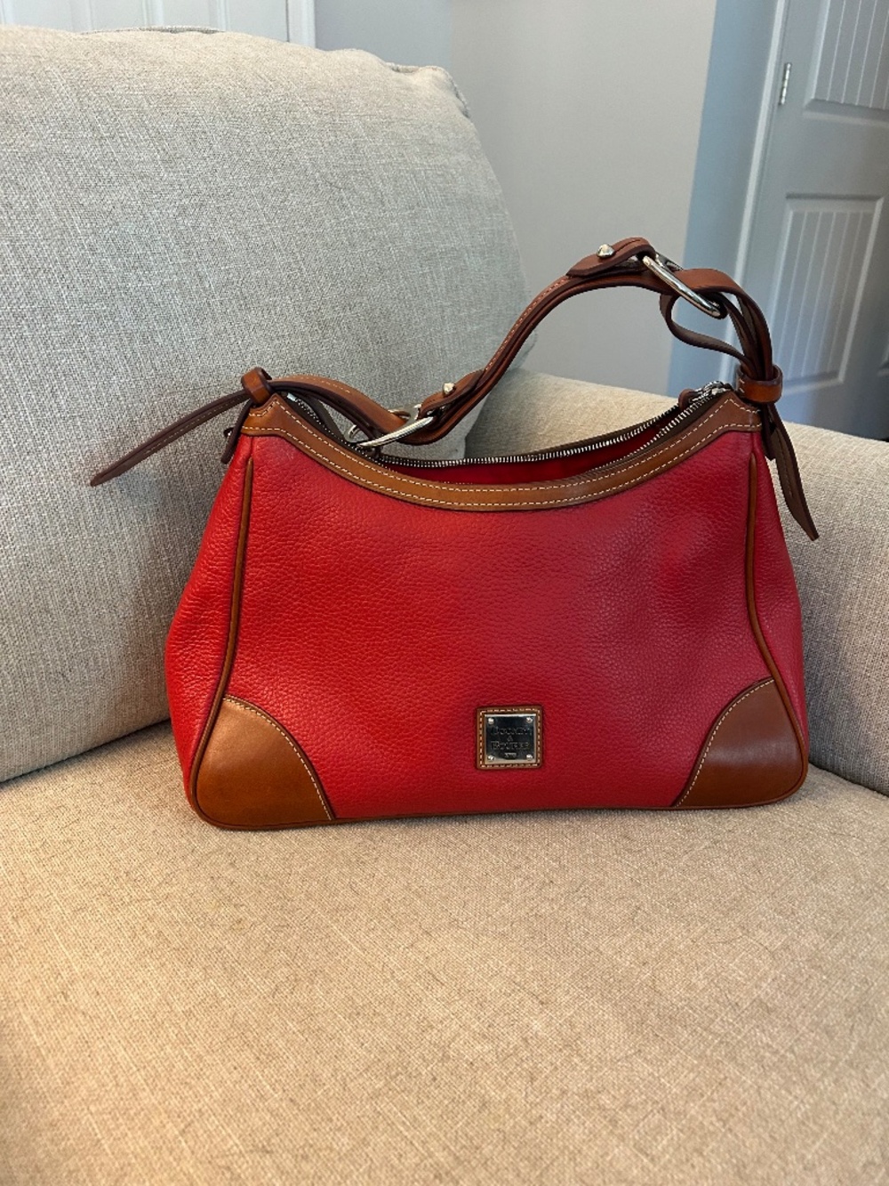 A pebbled leather Dooney Bourke red bag. Like new only used two or three times.